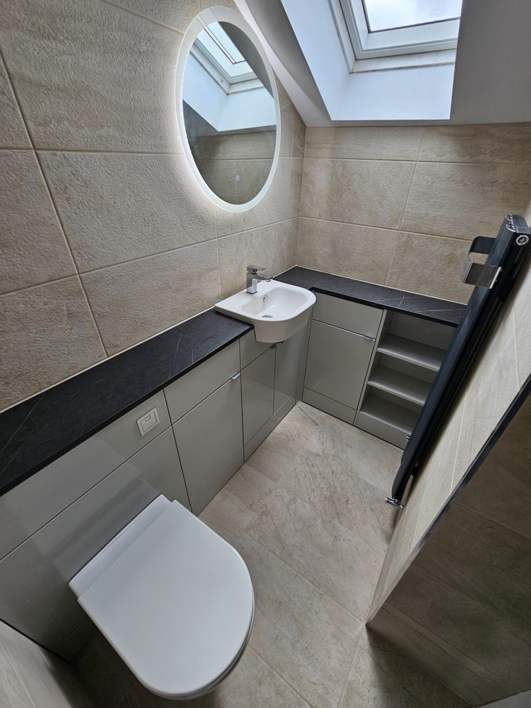 Beige stone tiled fitted bathroom supplied and installed by Premier Gas Burnley