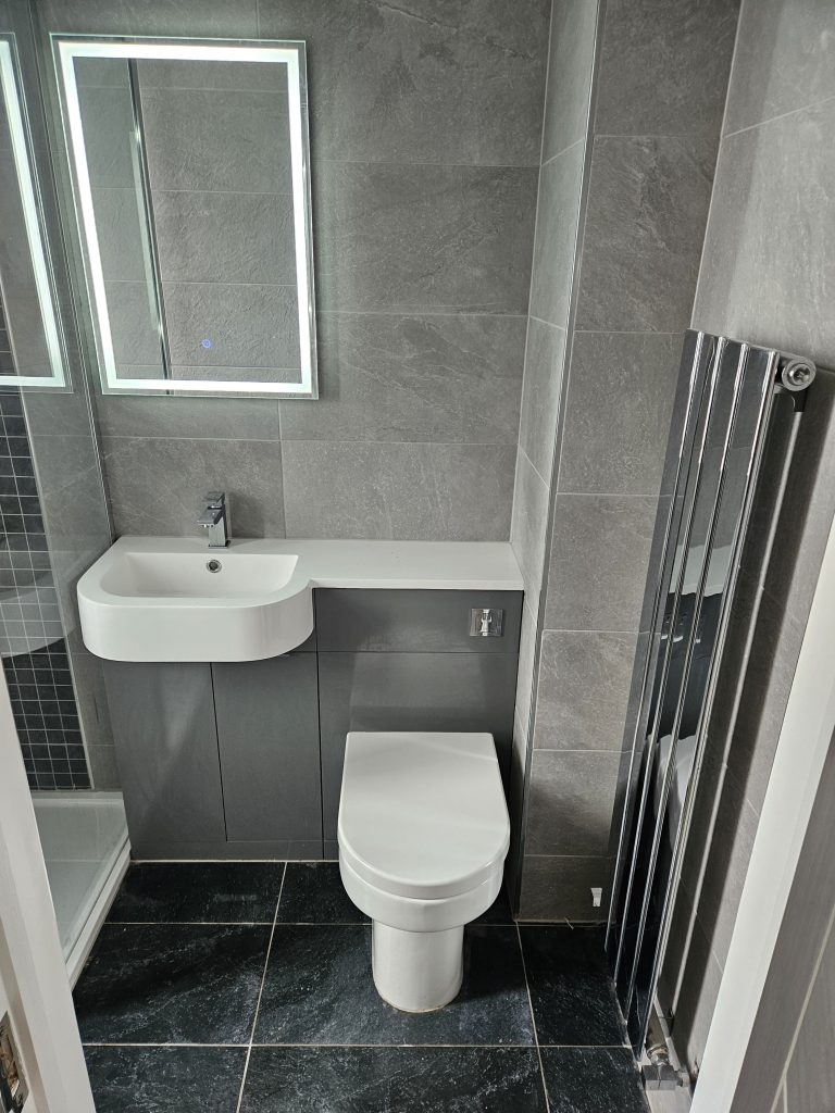 Grey slate tiled bathroom with vertical radiator, installed by Premier Gas Burnley