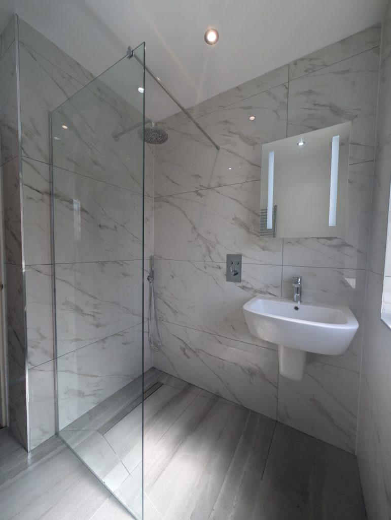 White marble walk-in shower room installed by Premier Gas Burnley